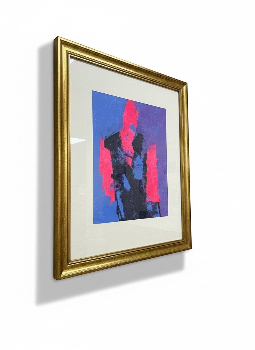 Chic Collective abstract figure wall art with pink, blue, and black on a gold frame.