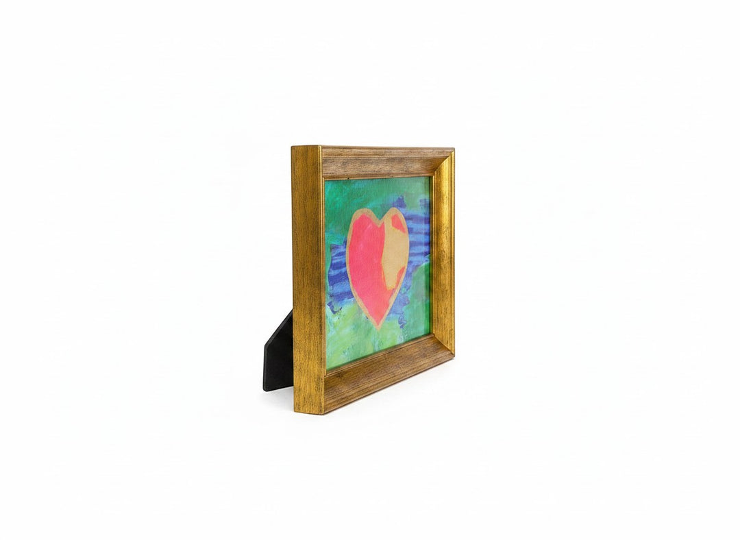 Chic Collective framed abstract art with a pink and gold heart on a textured green and blue background.