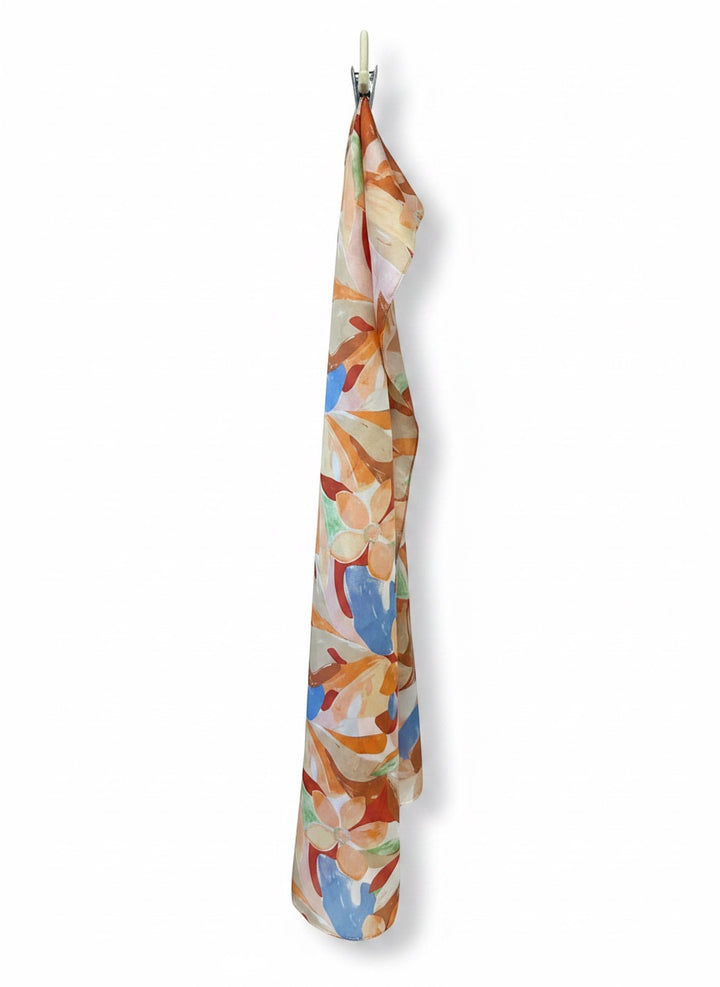 Chic Collective Amalfi Bloom Scarf, a silk scarf with painterly florals in citrus, peach, blue, coral, and green.