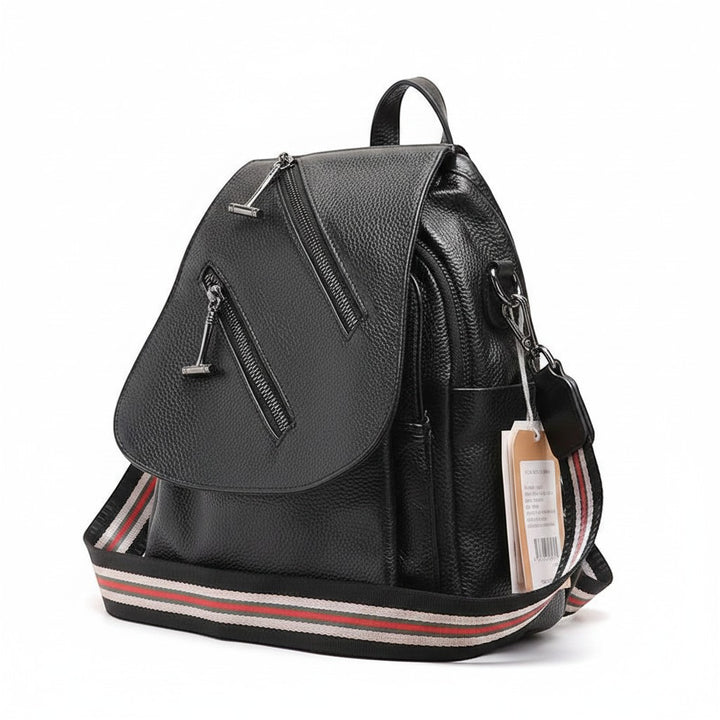 Chic Collective black textured leather backpack with diagonal zipper details and striped adjustable shoulder straps.
