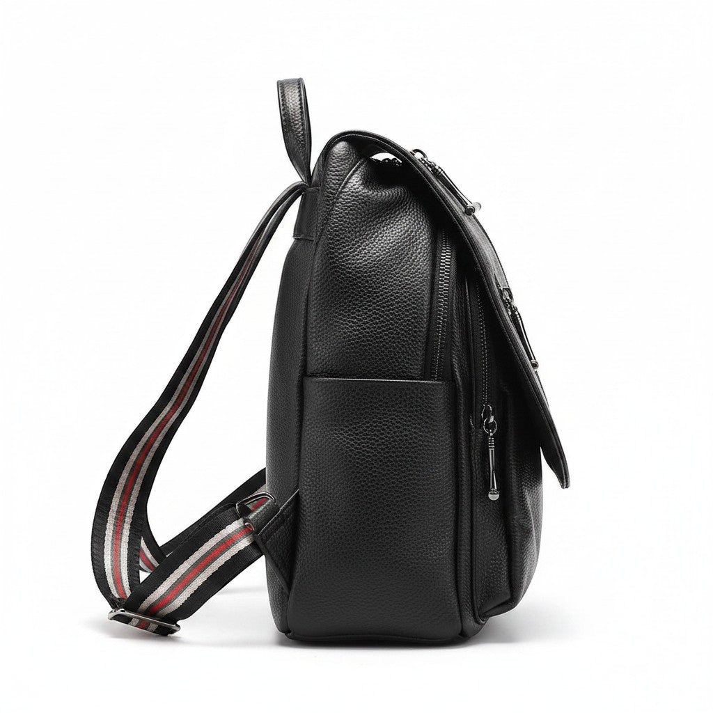 Chic Collective black textured leather backpack with diagonal zipper details and red, white, and black striped adjustable shoulder straps.