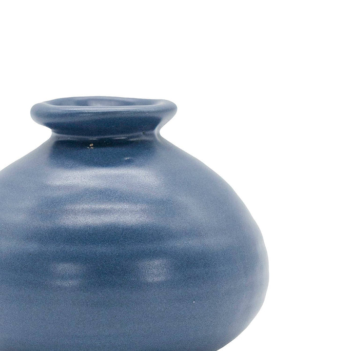 Chic Collective Mattie ceramic bud vase in a matte blue glaze with a ribbed texture. Perfect for single blooms or dried florals.
