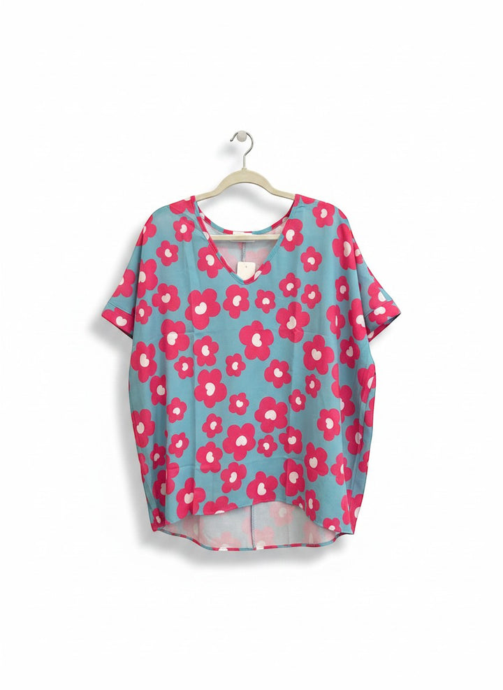 Chic Collective blue V-neck top with bold pink and white floral print, short cuffed sleeves.