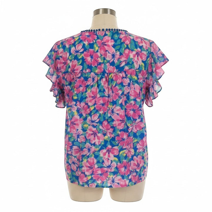 Chic Collective blue and pink hibiscus floral ruffle top with blue pom-pom trim.