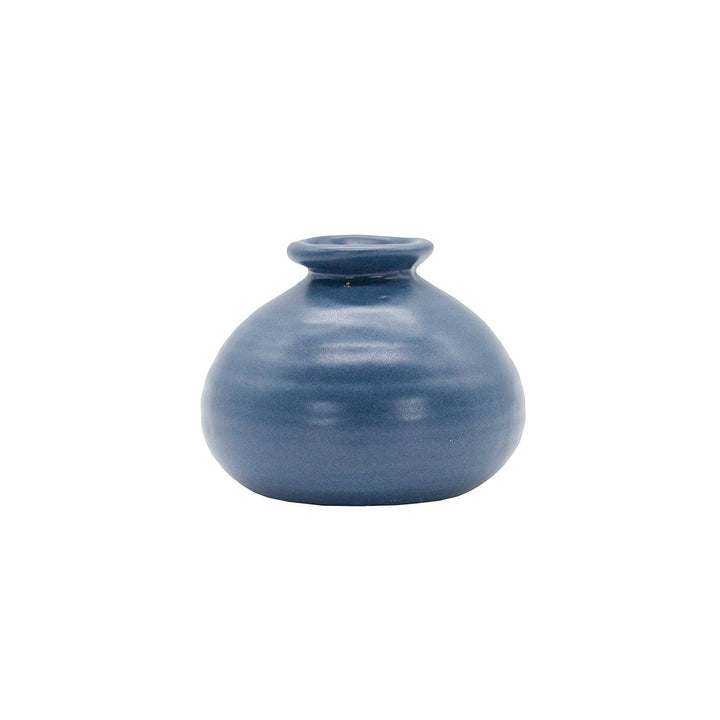 Chic Collective Mattie blue stoneware ribbed bud vase, perfect for single blooms or dried florals. Features a matte glaze and watertight design.
