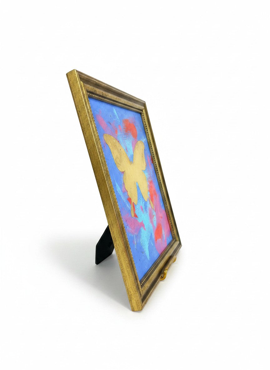 Chic Collective Celestial Flight framed artwork with gold butterfly on periwinkle, cobalt, orchid, and coral background.