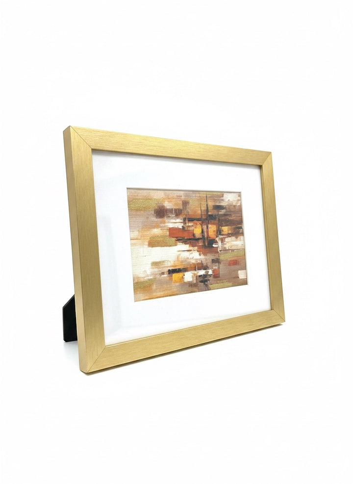 Chic Collective City Lights at Dusk abstract art with warm caramel, ivory, gold, and espresso geometric forms in a brushed gold frame.