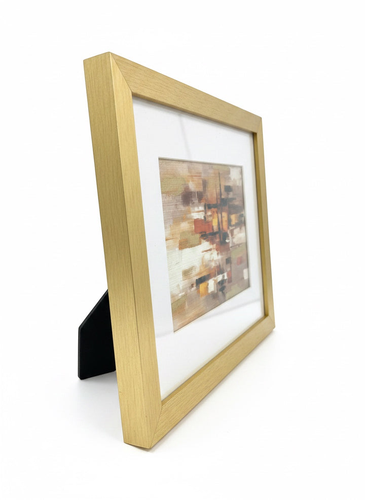 Chic Collective City Lights at Dusk abstract art with warm caramel, ivory, gold, and espresso tones in a brushed gold frame.