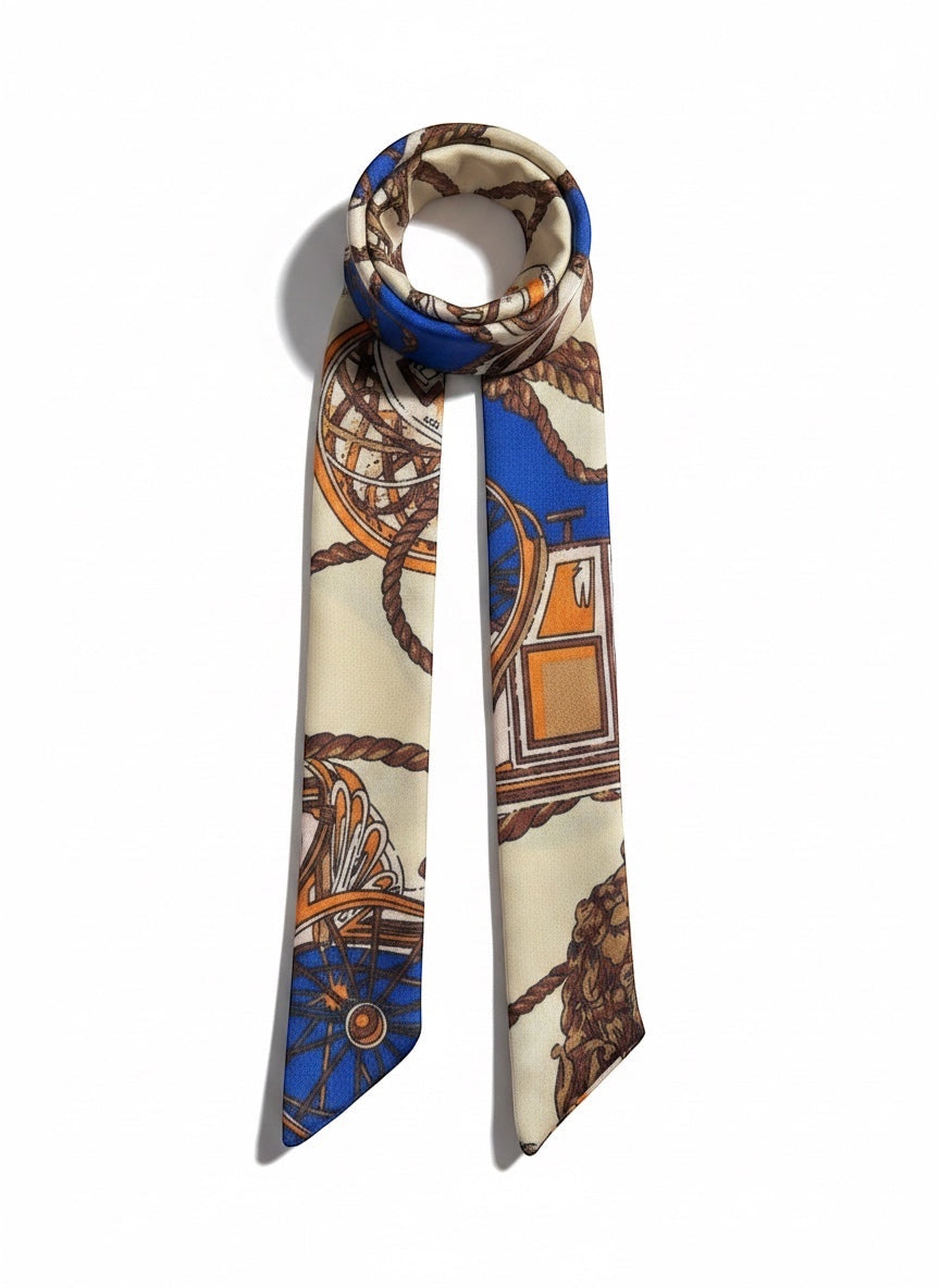 Chic Collective The Coastal Carriage Ribbon Tie, a silky scarf with a nautical print in cobalt blue, camel, ivory, and orange.