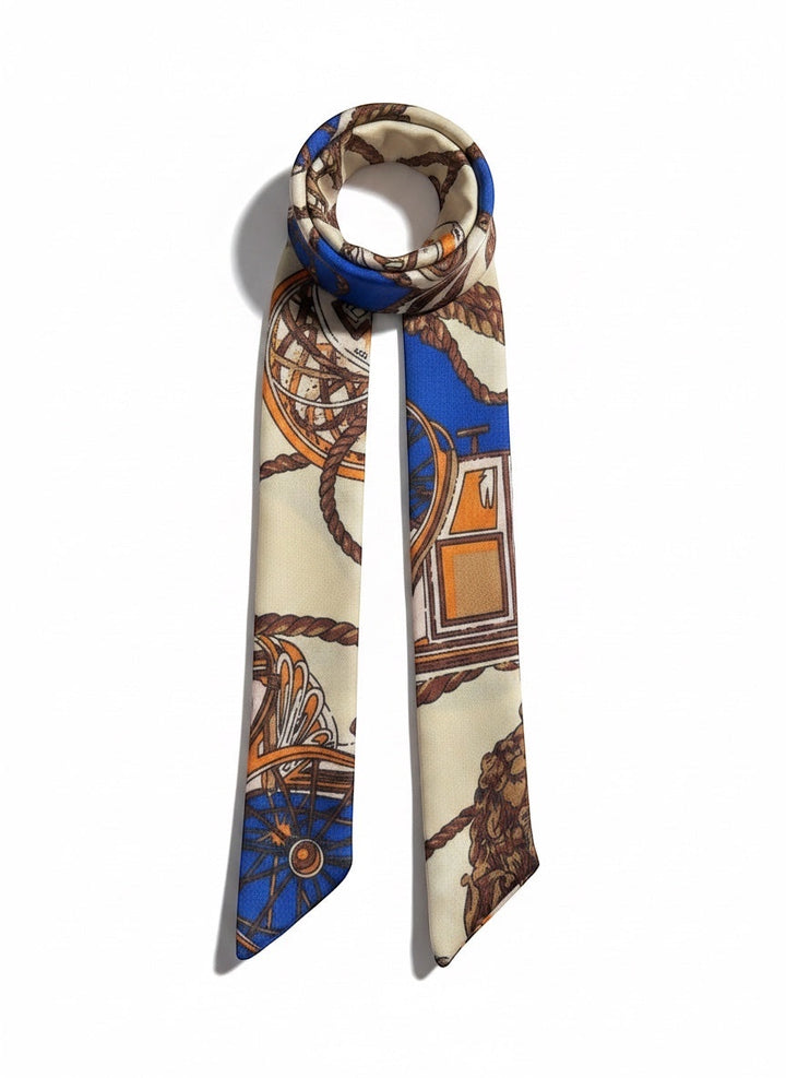 Chic Collective The Coastal Carriage Ribbon Tie, a silky scarf with a nautical print in cobalt blue, camel, ivory, and orange.