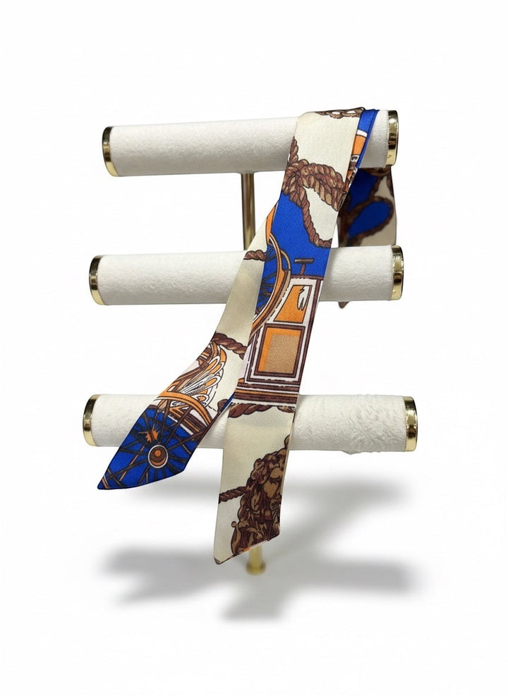Chic Collective Coastal Carriage Ribbon Tie: silky scarf with nautical rope, carriage, and wheel print in blue, camel, ivory, and orange.