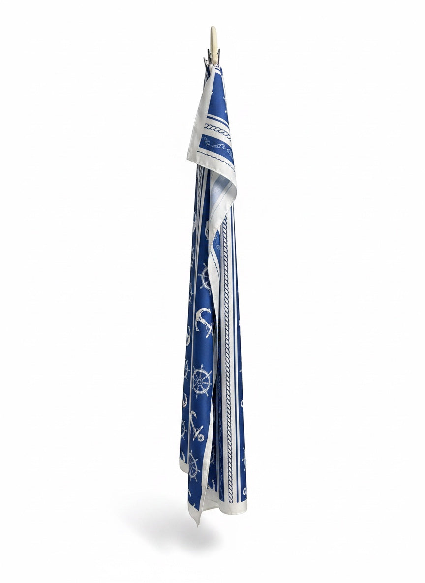 Chic Collective Coastal blue scarf with ivory anchors, ship wheels, rope, and stripes. Lightweight nautical accessory.