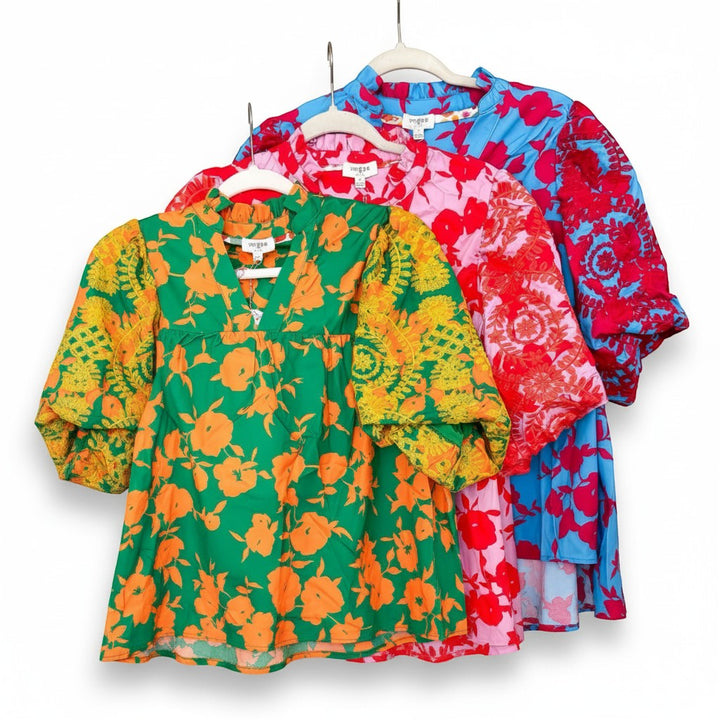 Chic Collective embroidered tops in green with orange floral print, pink with red floral print, and blue with red floral print. V-neck, puff sleeves.
