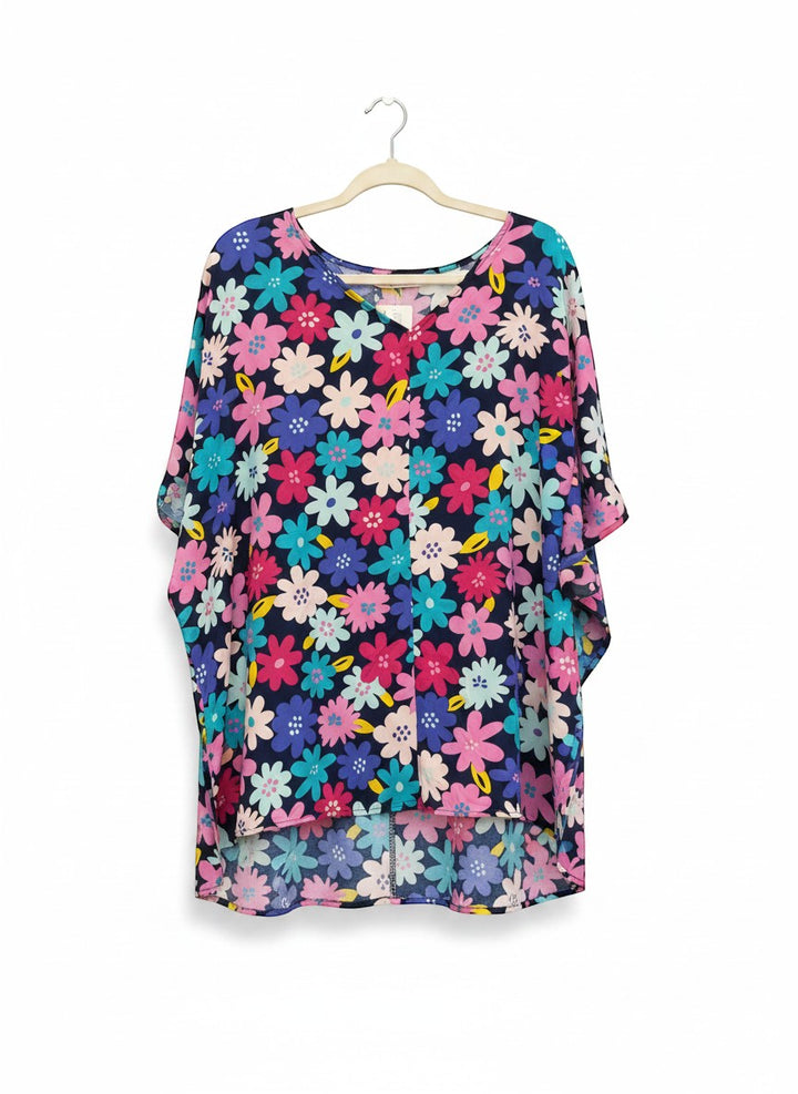 Chic Collective navy blue kaftan top with a vibrant all-over floral print in pink, blue, and yellow. Features a V-neck and flowy sleeves.