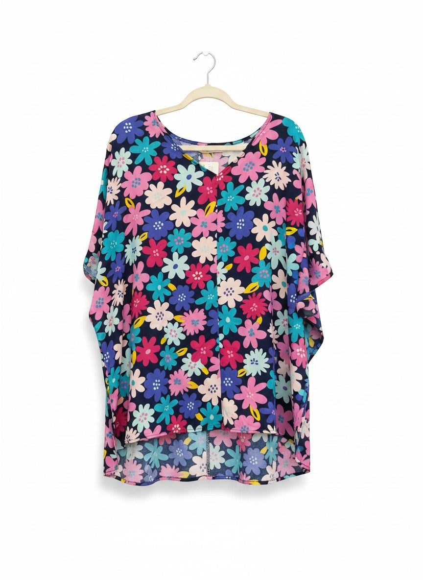 Chic Collective navy blue kaftan top with a vibrant all-over floral print in pink, blue, and yellow. Features a V-neck and flowy sleeves.