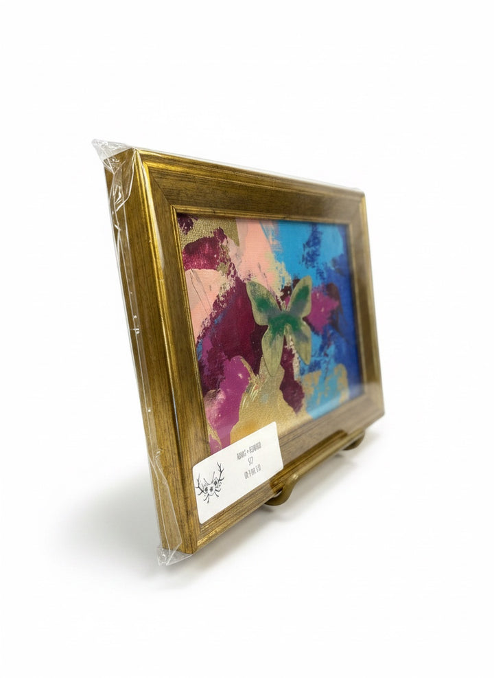 Chic Collective Flutter &amp; Bloom framed abstract art with butterfly motif in sapphire, plum, pink, green, and gold.