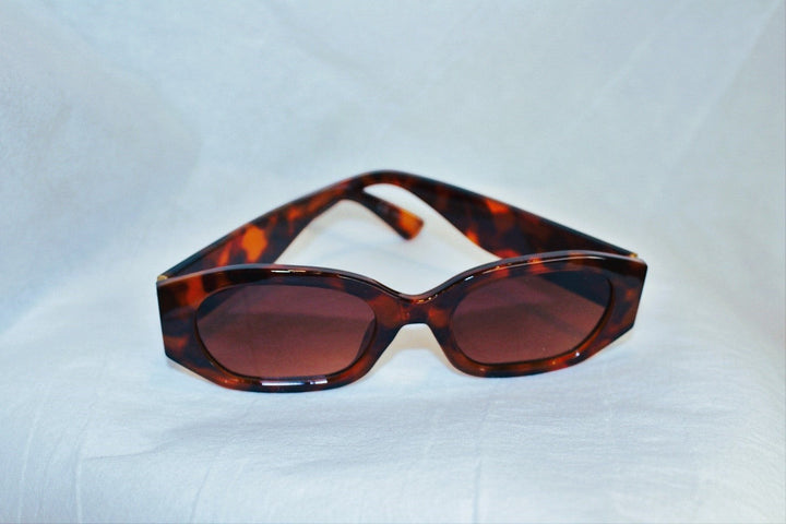 Chic Collective geometric frame sunglasses with tortoise shell pattern and gradient lenses.