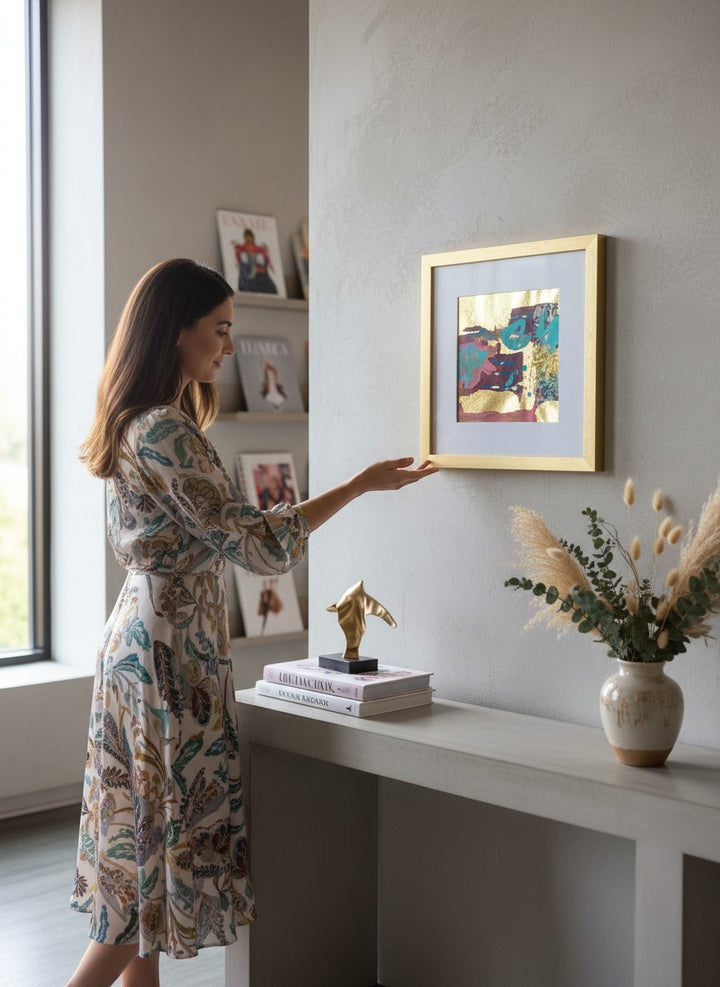 Chic Collective Gilded Whimsy abstract artwork with turquoise, raspberry, plum, and gold leaf textures. Framed in gold.
