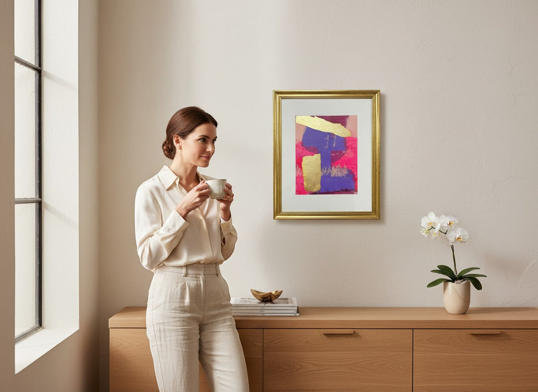 Chic Collective Golden Divide abstract art with fuchsia, violet, and gold leaf accents, framed in gold.