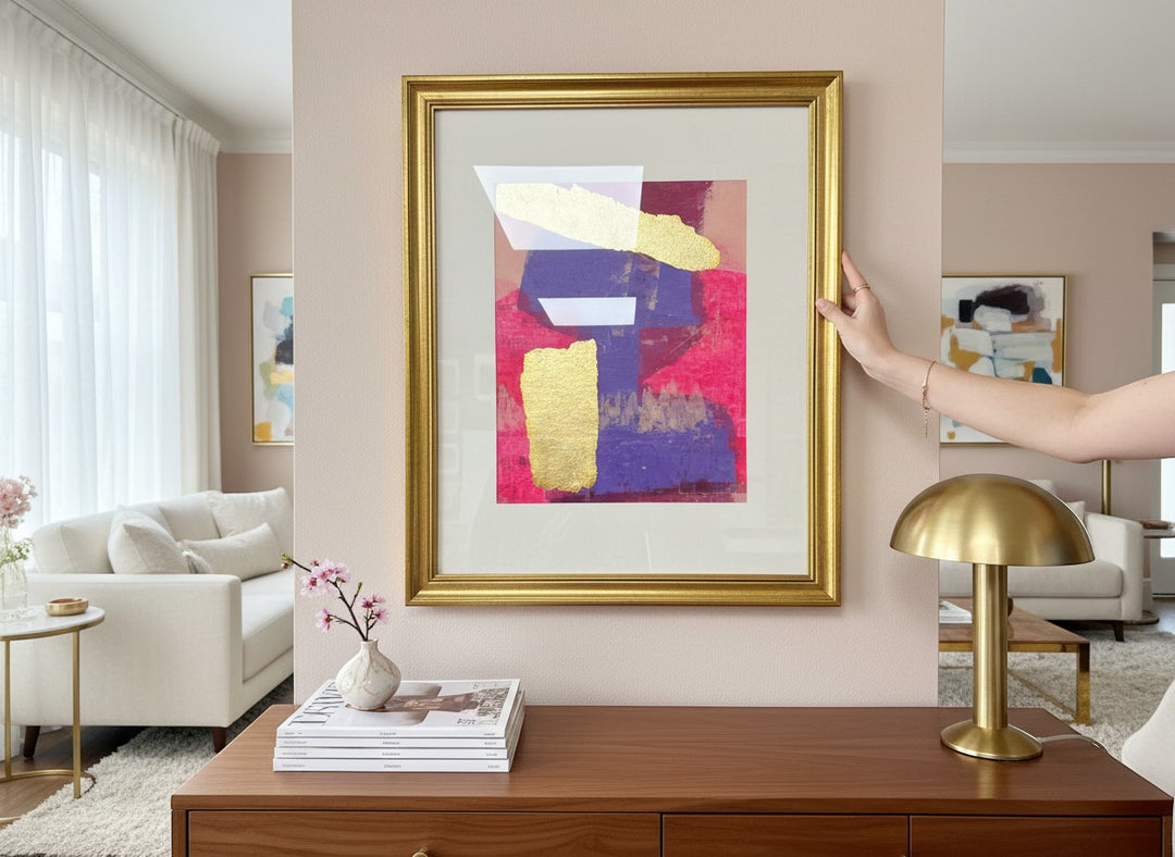 Chic Collective Golden Divide abstract art with fuchsia, violet, and gold leaf texture in a gold frame.