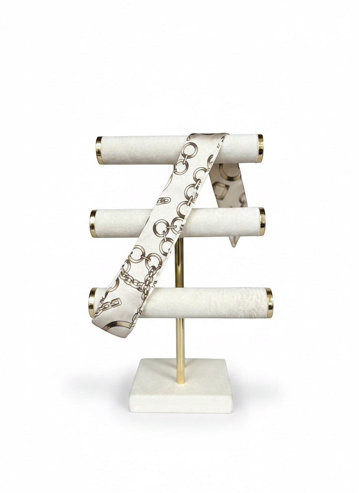 Chic Collective Golden Link Ribbon Tie, a silky scarf with a chain-link print in ivory and gold tones.