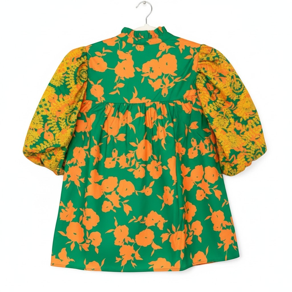 Chic Collective green dress with orange floral print and contrasting yellow embroidered sleeves. High neck with ruffled collar and puff sleeves.