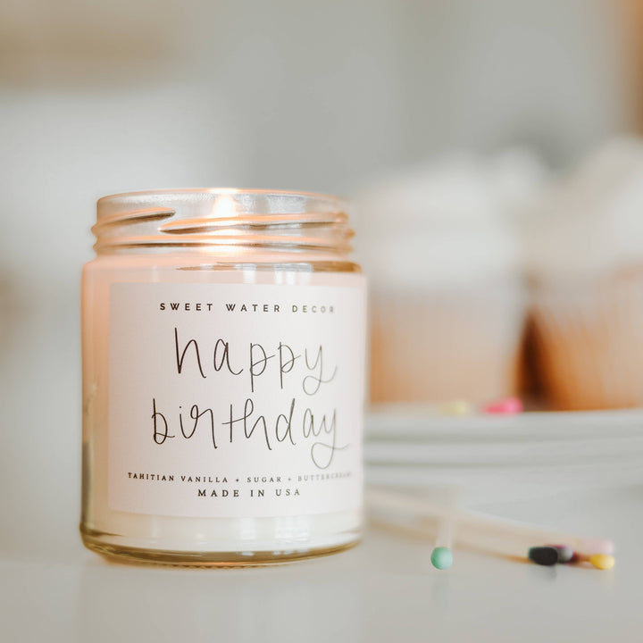 Chic Collective Happy Birthday vanilla buttercream scented soy candle in a clear jar with a light pink label.