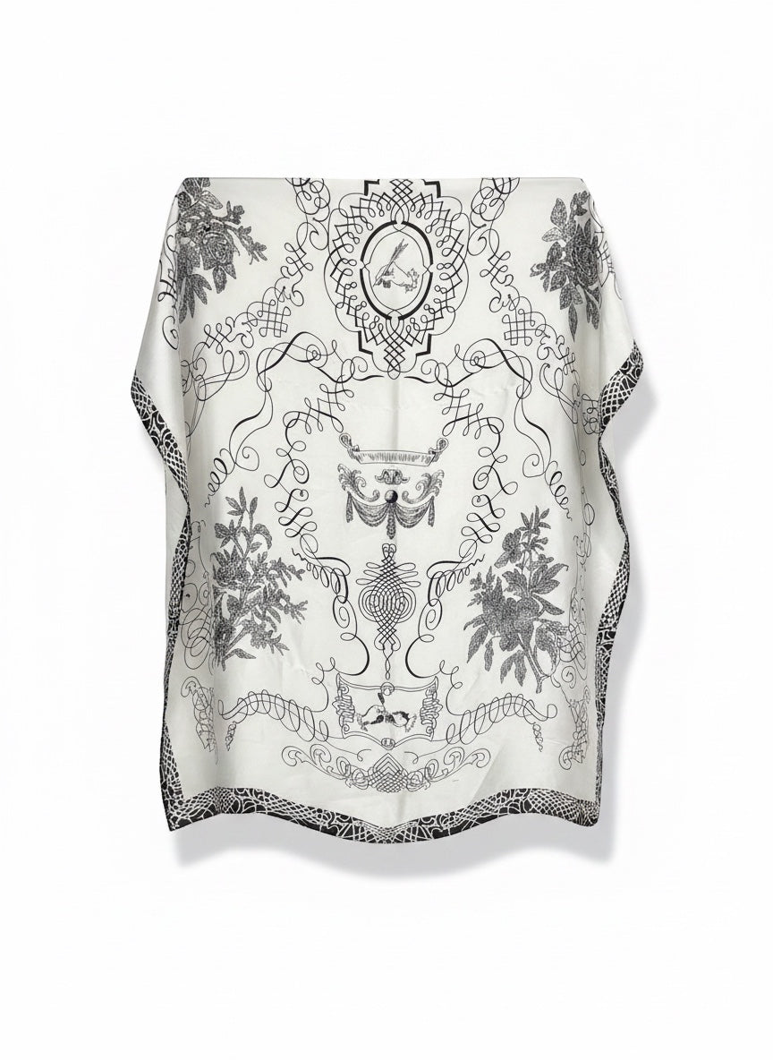 Chic Collective ivory satin scarf with black ornamental detailing, botanical motifs, and architectural linework.