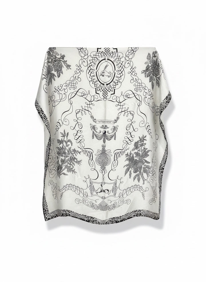 Chic Collective ivory satin scarf with black ornamental detailing, botanical motifs, and architectural linework.