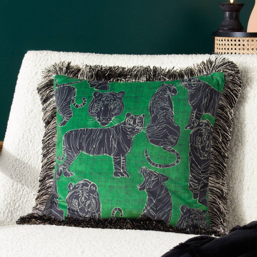 Chic Collective jungle green velvet cushion with a black and white tiger print and a black fringe.