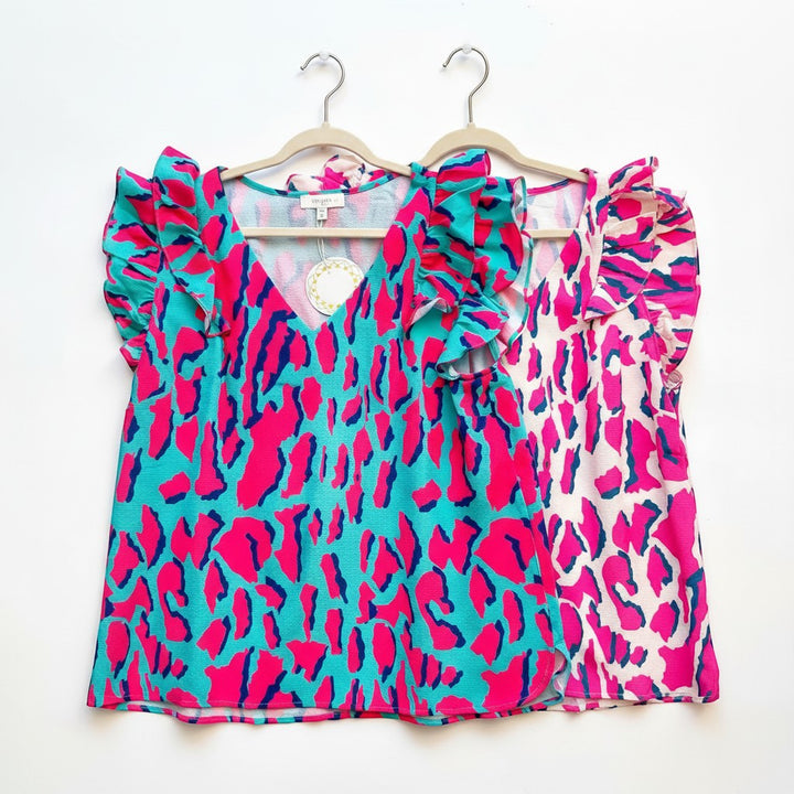 Chic Collective two leopard print tops, one in aqua with pink and navy, the other in cream with pink and navy. Both feature V-necks and ruffled short sleeves.
