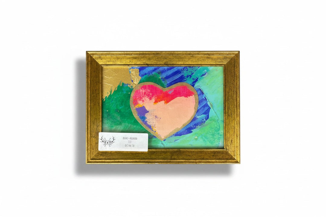 Chic Collective Luminous Wings abstract heart painting with gold frame. Jewel tones of purple, blue, and green with a pink and peach heart.
