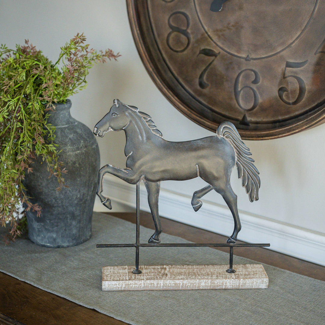 Chic Collective dark grey metal horse figurine on distressed wood base with metal stand, 13.5 inches tall.