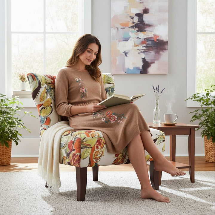 Chic Collective modern abstract armless slipper chair with colorful floral print upholstery and solid wood legs. Woman reading in chair.