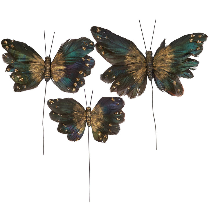 Chic Collective Moody Butterfly Pick Set features three decorative butterflies in dark green, blue, and gold with glitter and feather details on wires.
