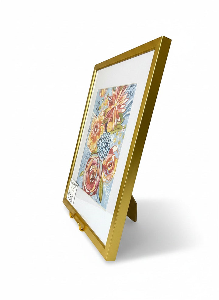 Chic Collective Morning Bloom Society framed art print with coral, blush, and golden marigold flowers on sky blue background.