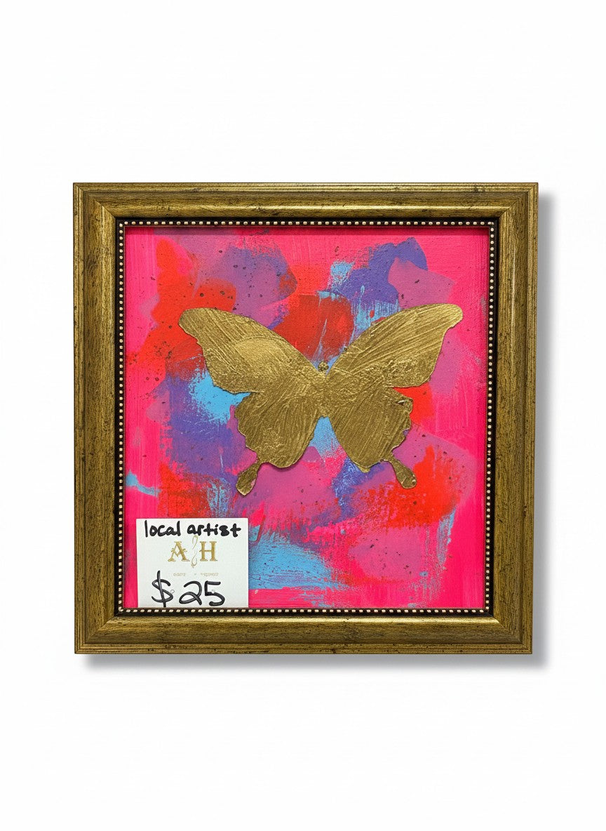 Chic Collective Neon Flutter artwork: metallic gold butterfly on vibrant pink, coral, violet, and blue abstract background, antique gold frame.