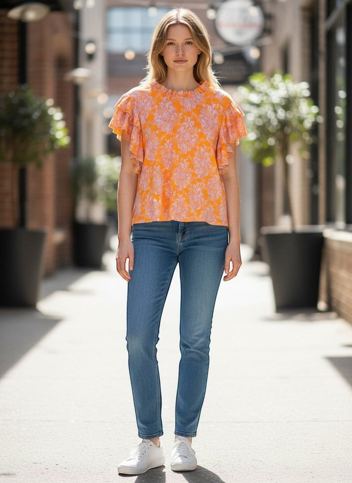 Chic Collective orange floral mock neck double layered ruffle top with short flutter sleeves worn by a model.