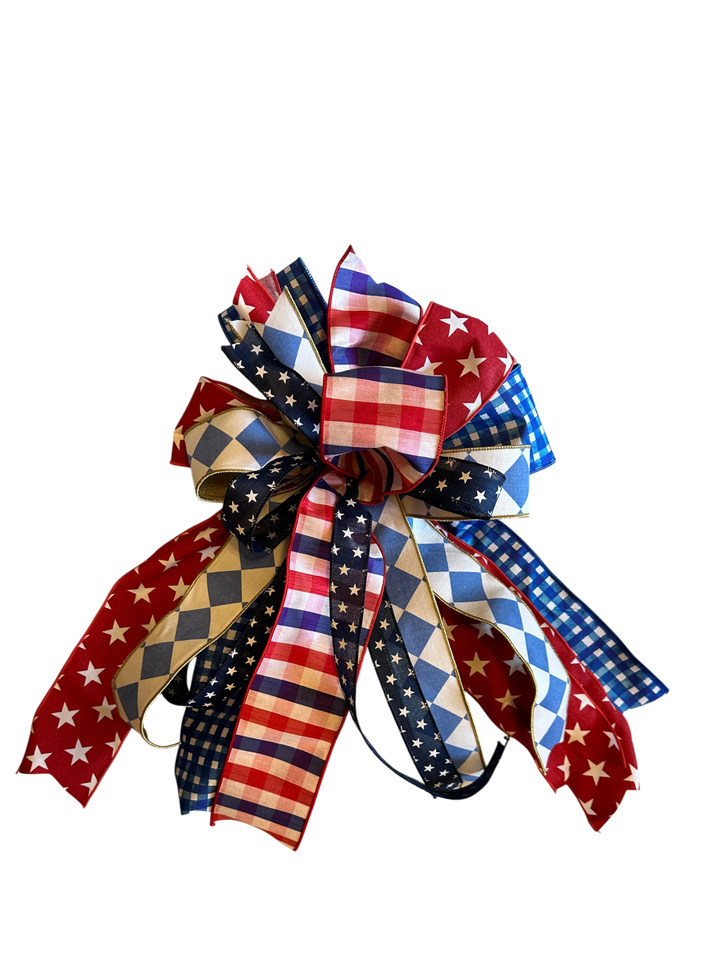 Chic Collective patriotic decorative bow with red, white, and blue stars, stripes, gingham, and diamond patterns.