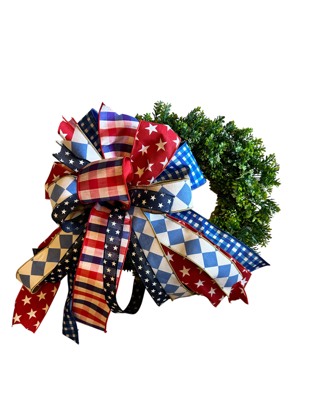 Chic Collective patriotic bow with red, white, and blue stars, stripes, gingham, and diamonds on a wreath.