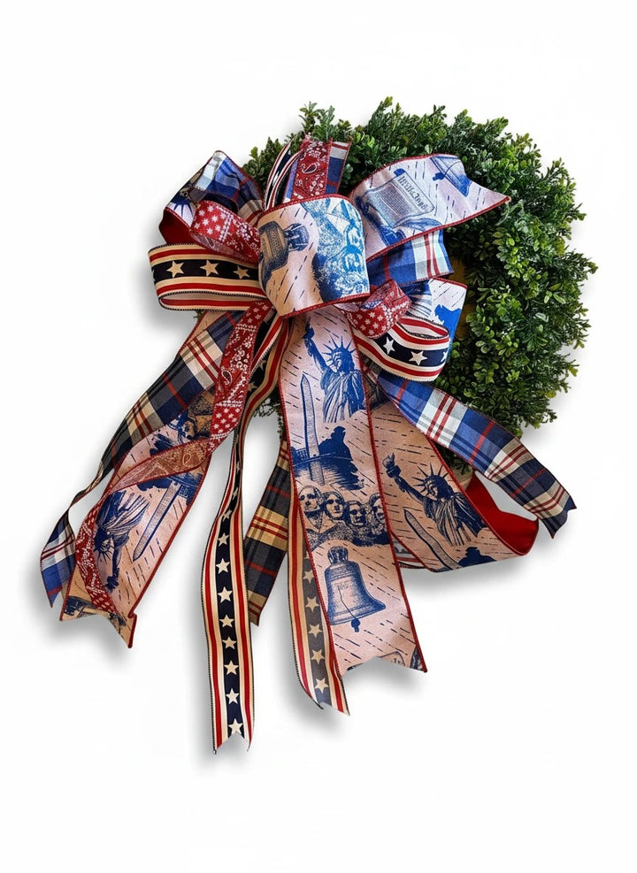 Chic Collective patriotic bow with Statue of Liberty, Mount Rushmore, and Liberty Bell prints on plaid ribbon.