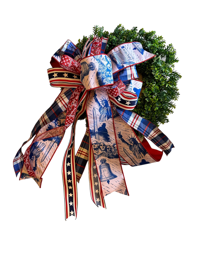 Chic Collective patriotic bow with Statue of Liberty, Mount Rushmore, and Liberty Bell prints on red, white, and blue ribbons.