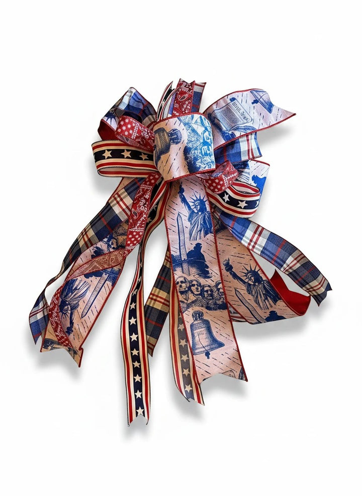 Chic Collective patriotic bow with Statue of Liberty, Mount Rushmore, and Liberty Bell prints. Red, white, and blue.