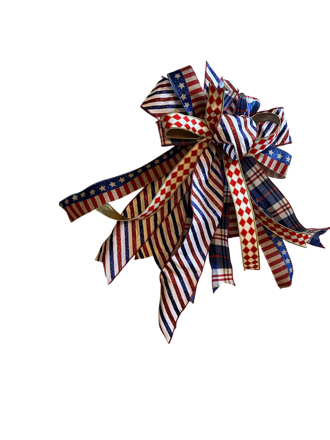 Chic Collective patriotic ribbon bow wreath decoration with red, white, and blue stars, stripes, and plaid patterns.