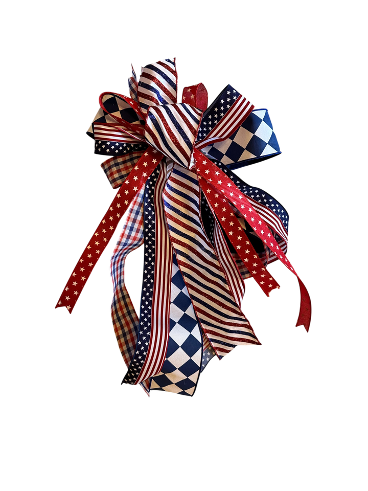 Chic Collective patriotic bow with red, white, and blue ribbons featuring stars, stripes, and checkered patterns. Perfect for wreaths.