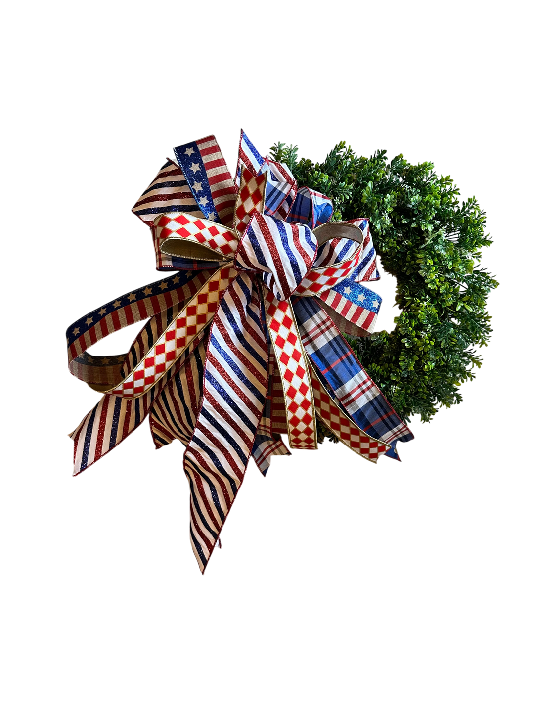 Chic Collective patriotic ribbon bow wreath decoration with red, white, and blue stripes, stars, plaid, and diamond patterns.