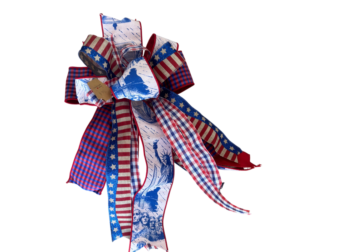 Chic Collective patriotic ribbon bow featuring Statue of Liberty, Mount Rushmore, stars, stripes, and gingham pattern.