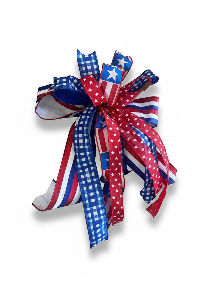 Chic Collective patriotic ribbon bow featuring red, white, and blue gingham, striped, and star patterns for home decor.