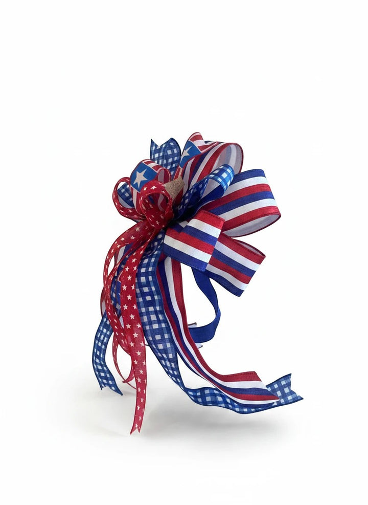 Chic Collective patriotic ribbon bow with red, white, and blue gingham, stripe, and star patterns for holiday decor.