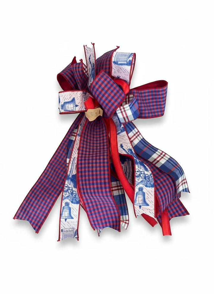 Chic Collective patriotic ribbon bow with red, white, and blue plaid and Liberty Bell patterns for holiday decor.
